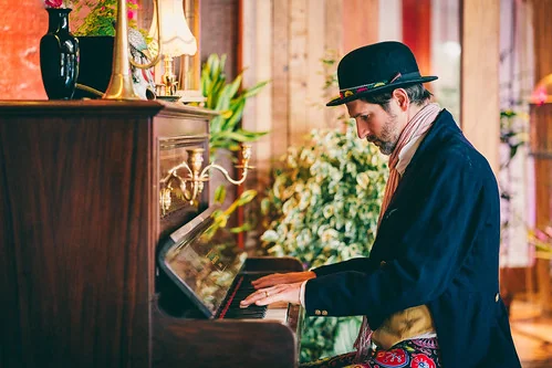 Guy playing upright piano